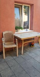 a wooden table and a chair next to a window at Villa Riba center Eco zone in Chişinău