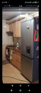 a kitchen with a stainless steel refrigerator and a stove at Villa Riba center Eco zone in Chişinău