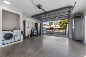 a garage with a washer and dryer in a house at Te Henui Outlook in New Plymouth