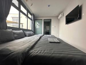 a large bed in a room with a large window at Dalat Family Center in Da Lat