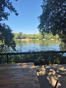 a view of a river from a wooden bridge at Vikendica na Tisi in Ada +9 photos