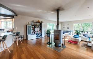 a living room with a fireplace and a kitchen at Cozy Home In Sarliac With Wifi in Bujadelle