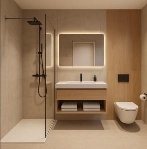 a bathroom with a sink and a toilet and a shower at Apartmenthaus Gilden 7 in Borken