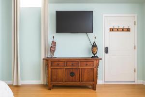 a tv on top of a wooden dresser in a room at Malibu 2BR In Woods Close To Beach in Malibu