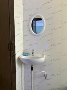 a bathroom with a sink and a mirror on the wall at DXK Villa Homestay in Guwahati