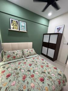 a bedroom with a bed with a floral bedspread at Middle Room Only in Bayan Lepas Shared Bathroom in Bayan Lepas
