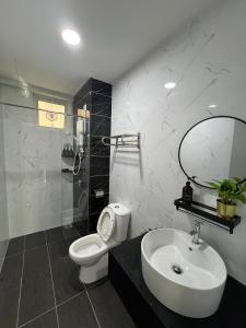 a bathroom with a toilet and a sink and a shower at Middle Room Only in Bayan Lepas Shared Bathroom in Bayan Lepas