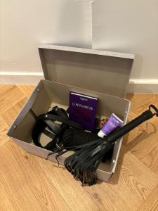 a box with a book and wires on the floor at Suite Secrète in Sélestat