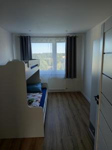 a small room with a bed and a window at 3-izbový byt in Prievidza