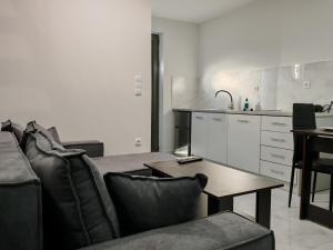 a living room with a couch and a table at Olympic Flame Suites in Pyrgos
