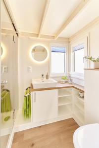 Un baño blanco con lavabo y ducha. en Moin Camp, en Ottersberg