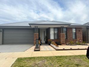 a brick house with a garage at Casa Amandah in Geelong