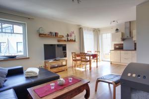a living room with a couch and a table at Strandvilla Börgerende in Börgerende-Rethwisch