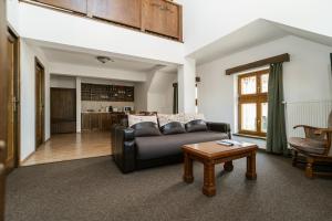 a living room with a couch and a table at Niki Apart Pension in Gheorgheni +86 photos