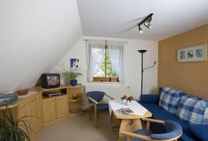a living room with a couch and a table at Ferienwohnungen Ihle in Kurort Altenberg