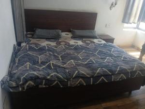 a bed with a quilt on it in a bedroom at Shumba home stay in Udhampur