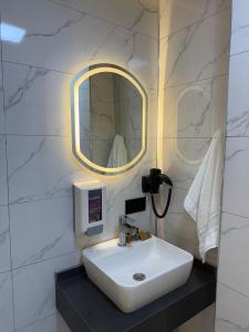 a bathroom with a sink and a mirror at Royal Sevens Otel in Ipekyolu