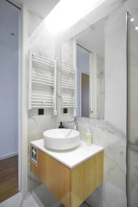 a white bathroom with a sink and a mirror at Belle Mar by MP in Canidelo +42 photos