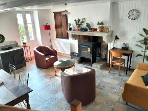 a living room with a couch and a fireplace at Charmante maison in Cugand