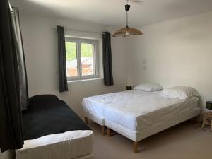 a bedroom with two beds and a window at Chalet Belleville in Béranger