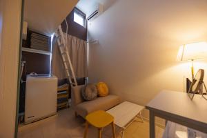 a small living room with a couch and a table at Cruise Inn Kitasenju Station Front1 in Tokyo