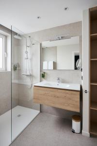 a bathroom with a sink and a shower at Georges Henri Aparthotel in Brussels +83 photos
