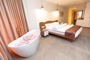 a bedroom with a bed and a bath tub at Eyes Of Egypt Pyramids View Boutique Hotel in Cairo