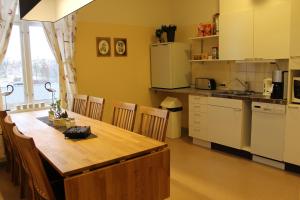 a kitchen with a wooden table and a counter top at Stationshusets Hotell och Café in Köping