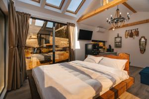 a bedroom with a large bed and a window at Cabana cu vedere spectaculoasa din pat - Apuseni Air Soare in Mătişeşti