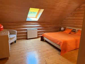 a bedroom with a bed in a wooden cabin at Villa Maxim in Skhidnitsa