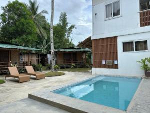 a swimming pool in front of a building at Tribal Xperience Guesthouse in San Vicente