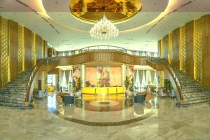 a lobby with stairs and a chandelier at Wyndham Grand KN Paradise Cam Ranh in Cam Ranh +150 photos
