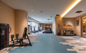 a gym with treadmills and treadleys in a building at Jianguo Hotel HUANQIU in Beijing