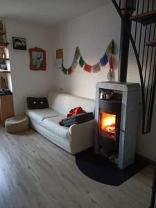 a living room with a couch and a fireplace at Chalet Bike & Family in Oga