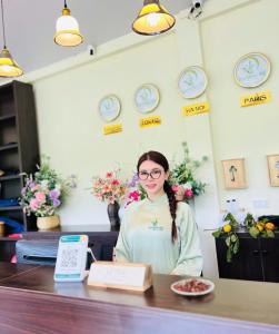 a woman sitting at a counter in a store at Bamboo Hill Resort in Hữu Lũng +96 photos