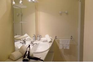 a bathroom with a sink and a shower with a mirror at Studio Revy 4 - Confort et équipé - Centre ville in Néris-les-Bains +30 photos