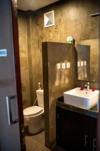 a bathroom with a toilet and a sink at Gili Ocean Club - ADULTS ONLY in Gili Trawangan +63 photos