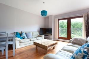 a living room with a couch and a table at The Rampling's in Crawley