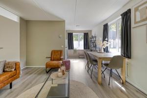 a living room with a table and a couch at Vakantiehuis - Brabantse gezelligheid met sauna VP098 in Hoeven