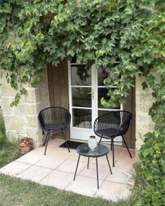 two chairs and a table in front of a window at Las Coussoulesses in Anthé +68 photos