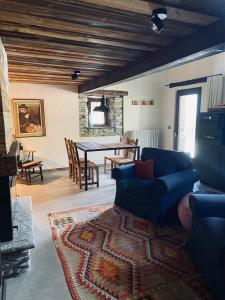 a living room with a blue couch and a table at Borgo Felice appartamento La Fontana in Monfol