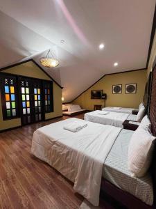 a large bedroom with two beds and a chandelier at La Traviesa Hotel Resort in General Trias