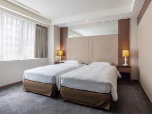 Postel nebo postele na pokoji v ubytování Green World Mai - NanJing