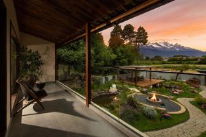 a balcony with a view of a garden and a fire pit at LiJiang Mountain Spring Resort in Baisha