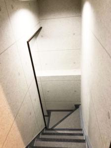 a staircase in a building with a stair case at R Inn 新井薬師前 in Tokyo