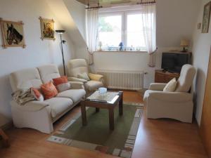 a living room with two couches and a coffee table at NEU! Ferienwohnung direkt am Deich in Neßmersiel