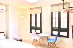 a bedroom with a bed and two chairs and a table at R Inn 新井薬師前 in Tokyo
