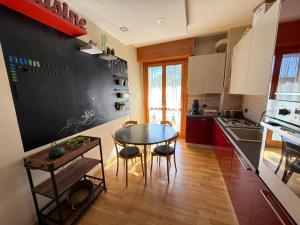 a kitchen with a table and a blackboard on the wall at The Kaktus House - vicino San siro e Rho Fiera in Milan +15 photos