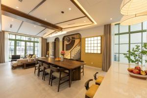 a dining room and living room with a table and chairs at Green Villas Phú Quốc in Phu Quoc