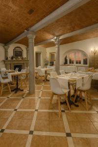 a dining room with tables and chairs on a checkered floor at Tenuta Monte Bago in Sant Andrea Bagni
